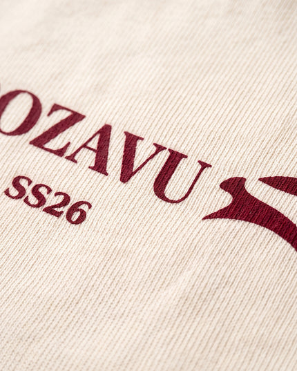 Extreme macro close-up of GROZAVU SS26 Cream T-Shirt showcasing premium heavyweight cotton fabric weave, fine ribbing, and razor-sharp graphic print detail