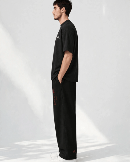 Side profile of the SS26 wide-leg pants showing the straight leg line