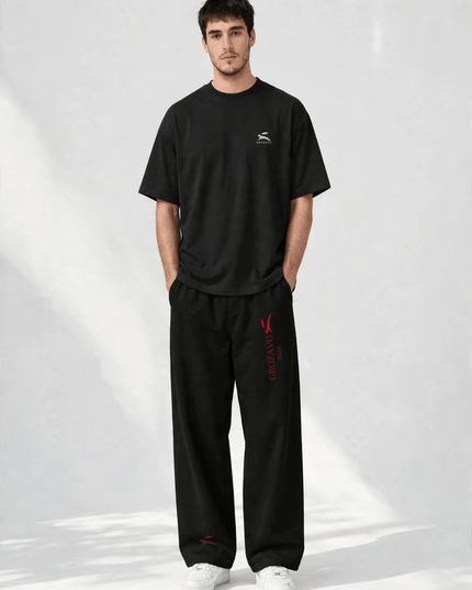 SS26 wide-leg pants with the deep red collection mark, studio front view