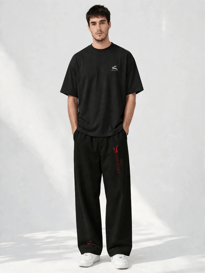 SS26 wide-leg pants with the deep red collection mark, studio front view