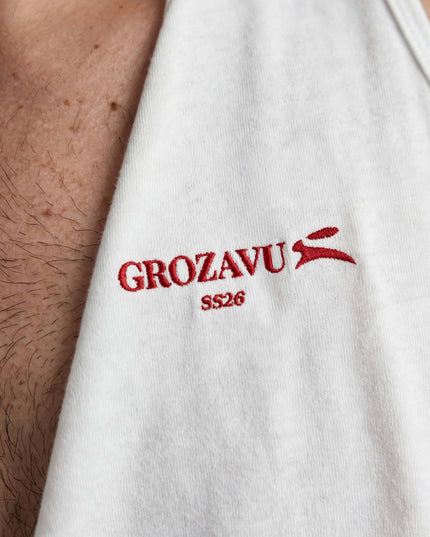 Macro of the embroidery on the white staple tank top
