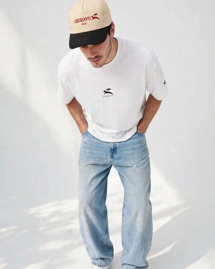 Low-angle portrait in the beige structured five-panel cap