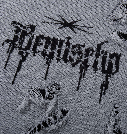 Close-up of the tassel distressed knit sweater with bold graphic design and distressed details.