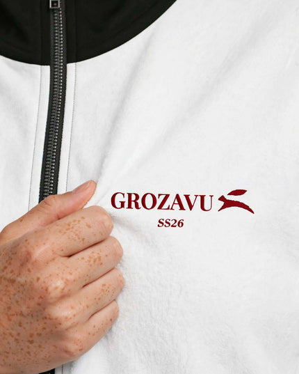 Embroidered logo close-up on the recycled polyester track jacket