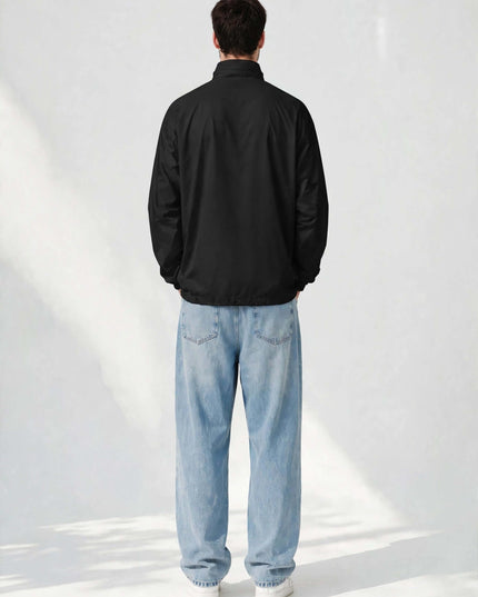 Back view of the black packable windbreaker with drawstring hood