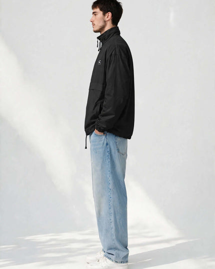 Studio side profile of the black lightweight windbreaker jacket