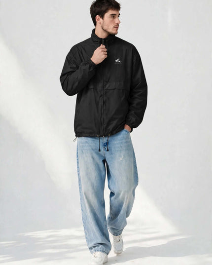 Model zipping the black windbreaker, showing the full-length zip