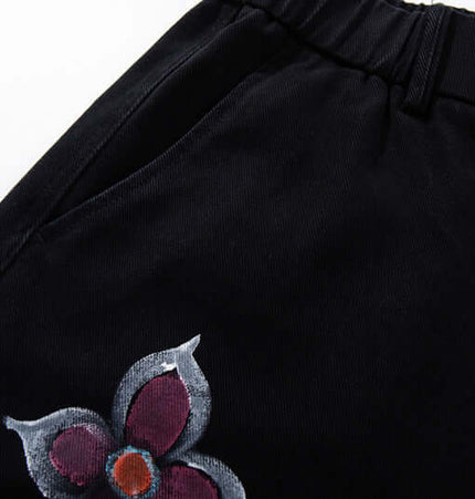 Graffiti Printed Cargo Denim Pants featuring hand-painted flower design on a black background.