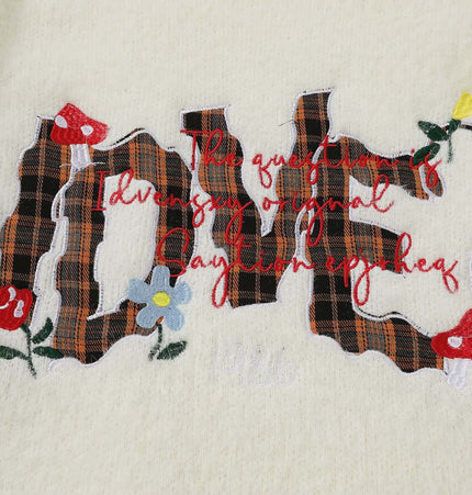 Knit Sweater with Letter Applique featuring hand-stitched plaid letters and floral design on a light knit fabric.