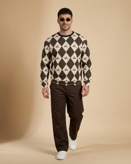 Hare Argyle Sweatshirt in Cocoa styled with brown trousers and white sneakers, full-length studio shot