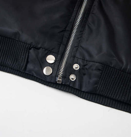 Close-up of the zipper and snap buttons on the Hawk Embroidered Letter Hooded Coat.