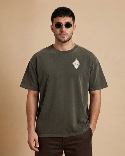 Model wearing the Heritage Diamond Tee in washed charcoal, front view with the hare diamond on the chest