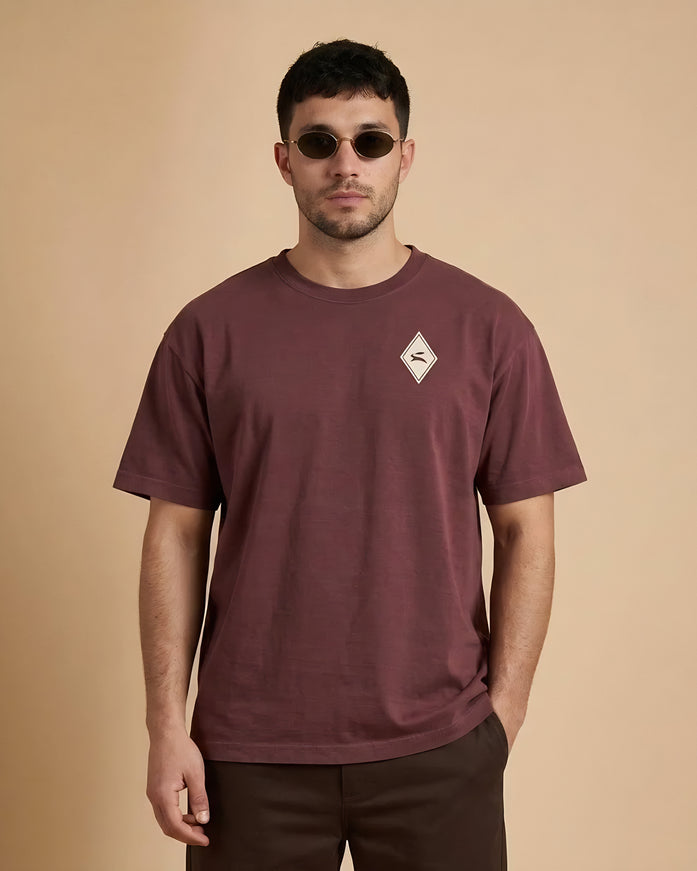 Model wearing the Heritage Diamond Tee in washed maroon, front view with the hare diamond on the chest