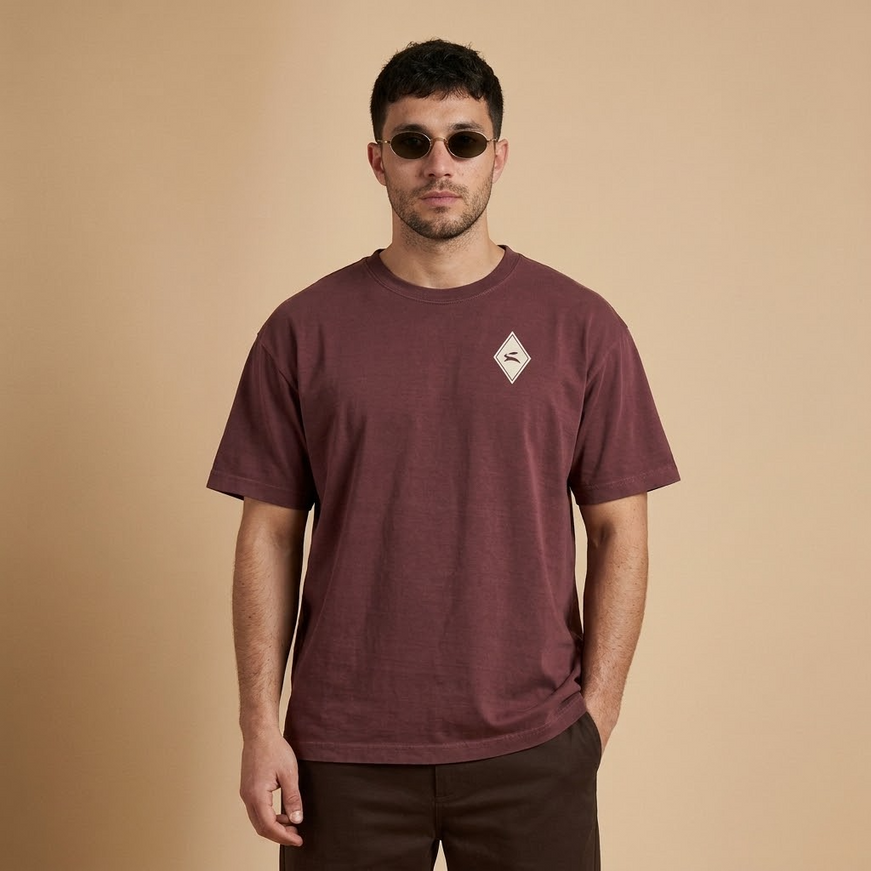 Model wearing the Heritage Diamond Tee in washed maroon, front view with the hare diamond on the chest
