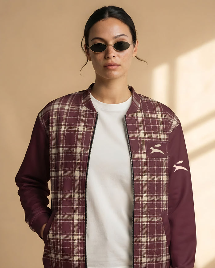 Model wearing the Heritage Tartan Bomber in Bordeaux open over a white tee, with the Grozavu hare patch on the chest