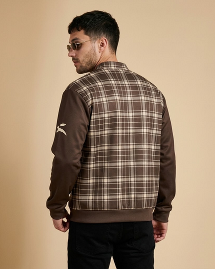 Model wearing the Heritage Tartan Bomber in Cocoa, back view with the hare on the left sleeve