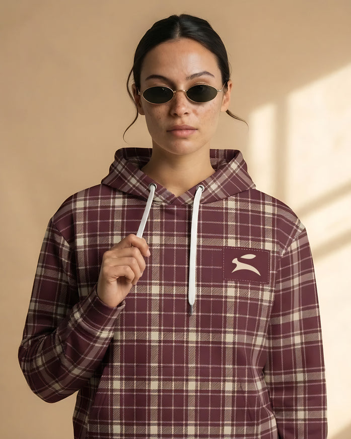 Model wearing the Heritage Tartan Hoodie in Bordeaux, front view with the Grozavu hare patch on the chest