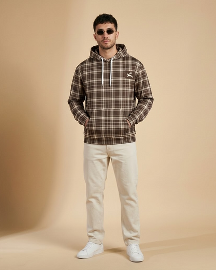 Model wearing the Heritage Tartan Hoodie in Cocoa in the studio, full-length front view