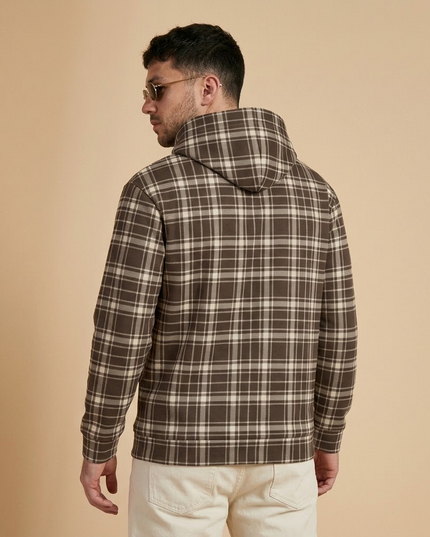 Model wearing the Heritage Tartan Hoodie in Cocoa, back view with the tartan hood