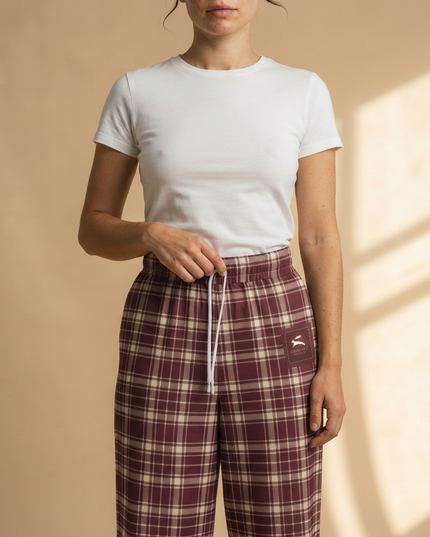 Close-up of the drawstring waist and the Grozavu Heritage label on the Heritage Tartan Wide-Leg Joggers in Bordeaux