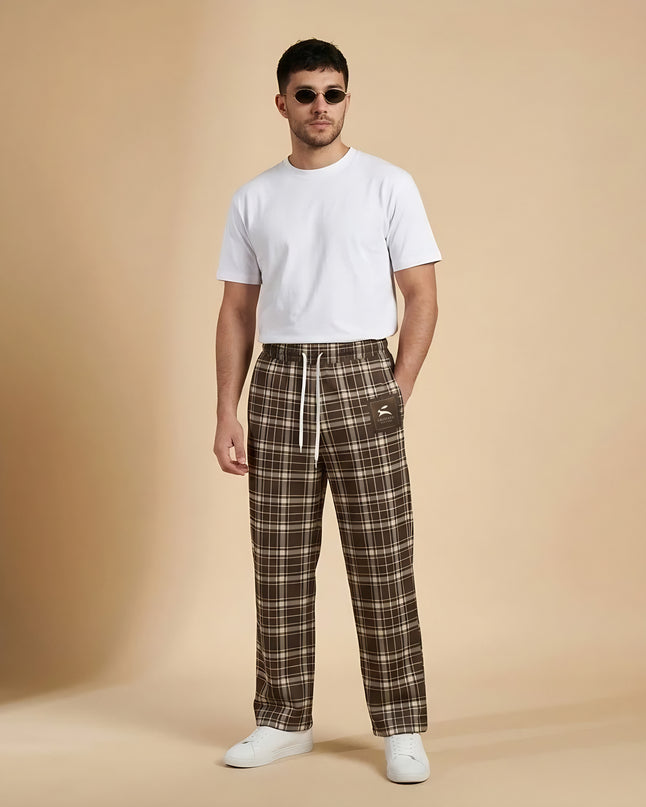 Model wearing the Heritage Tartan Wide-Leg Joggers in Cocoa in the studio, full-length front view