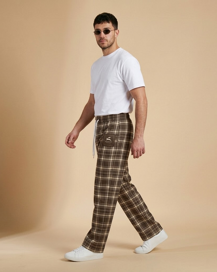 Model walking in the Heritage Tartan Wide-Leg Joggers in Cocoa, side view