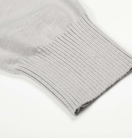 Close-up of the ribbed cuff of the High Neck Street Knit Sweater – Loose Fit in gray, showcasing its soft texture.