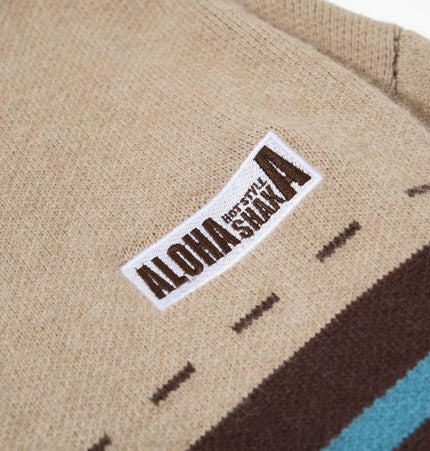 Close-up of the label on a High Neck Stripe Jacquard Cardigan showcasing ALOHA branding.