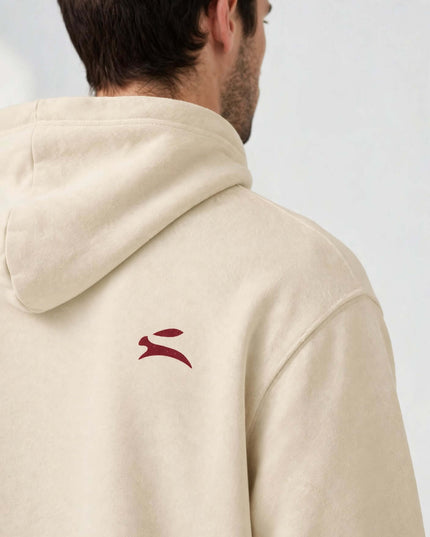 Shoulder logo detail on the beige mill-dyed hoodie