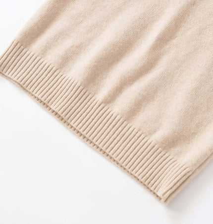 Close-up of the hemline of the Round Neck Casual Knit Sweater in a soft beige color, showcasing the ribbed detail.