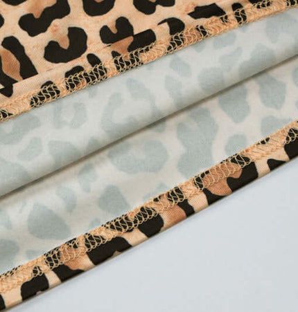 Close-up of fabric texture featuring the Leopard Print Strapless Crop Tank Top with detailed leopard patterns.