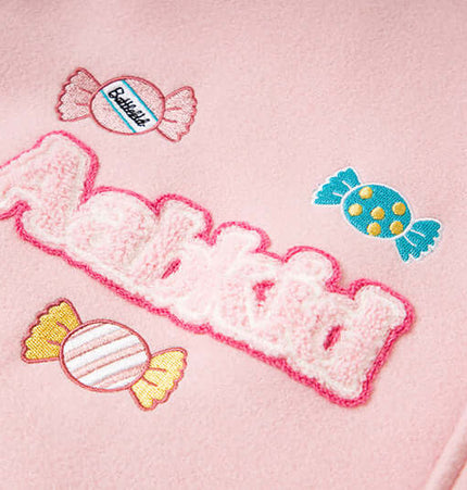 Close-up of playful letter embroidery and candy designs on the Letter Embroidery Colorblock Jacket.