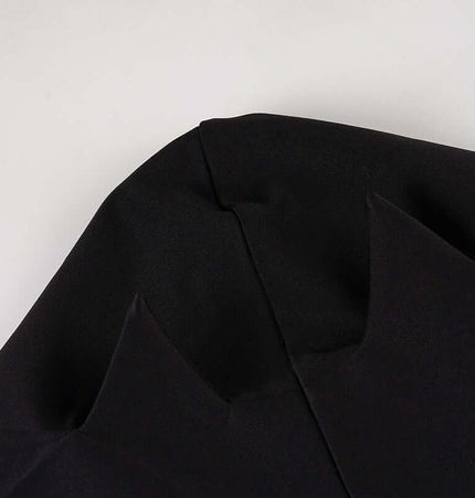 Close-up of the fabric detailing on the Long Sleeve Devil Hooded VNeck TShirt. Dark black material with unique shapes.