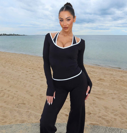 Long Sleeve Halter Neck Contrast Top worn on the beach, showcasing minimalist elegance and modern fashion appeal.