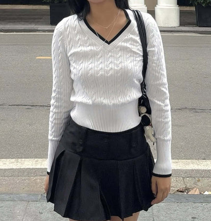 Long Sleeve VNeck Knit Top in white with cable knit design, paired with a black skirt for casual styling.