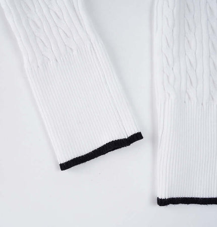 Long Sleeve VNeck Knit Top showcasing white cable-knit sleeves with black cuff detailing.