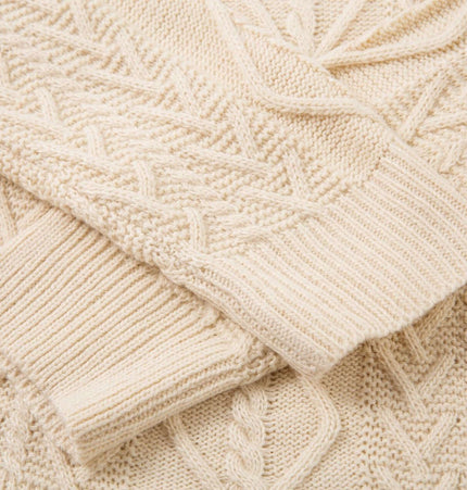 Loose Fit Knit Crewneck Sweater in cream, showcasing intricate knit patterns and ribbed cuffs for added style.
