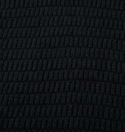 Close-up texture of a Loose Fit Plain Knit Sweater in black color, showcasing its soft, comfortable fabric.