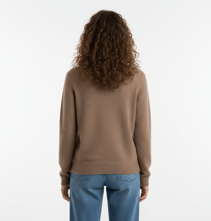 Back view of a woman wearing a Simple Loose Knit VNeck Top in camel color, showcasing its relaxed fit and long sleeves.