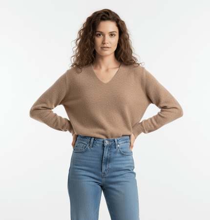 Loose Knit VNeck Top in camel color, featuring a relaxed fit and v-neckline, worn with high-waisted jeans.