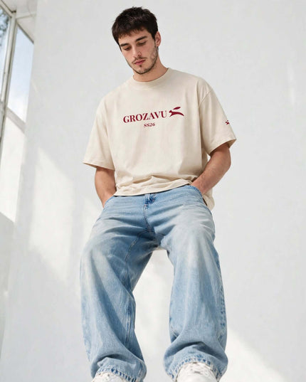 Low-angle portrait of the beige 237 g/m² heavyweight tee with drop shoulders