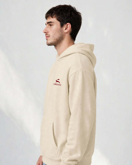 Side profile of the beige oversized hoodie with two-panel hood, no drawcords