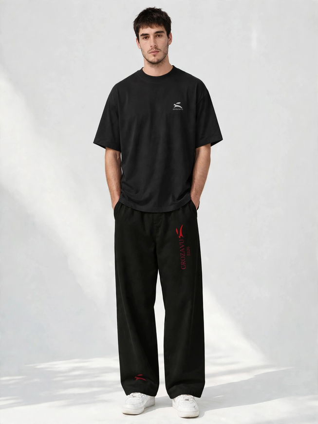 SS26 wide-leg pants with the deep red collection mark, studio front view