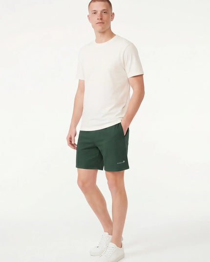 Lifestyle shot of the Maison Grozavu Sleek Umber Shorts in shorts — showing the structural collar.