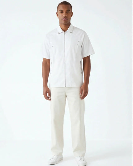 Lifestyle shot of the Maison Grozavu Chalk Shorts Series in shorts — showing the effortless drape.