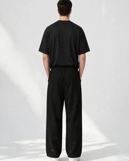 Back view of the SS26 wide-leg pants with the deep red mark