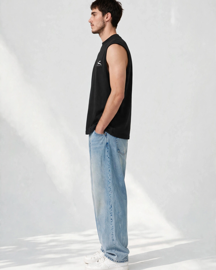 Side profile of the black sleeveless tee showing the deep low armhole