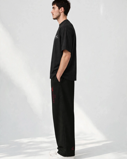 Side profile of the SS26 wide-leg pants showing the straight leg line