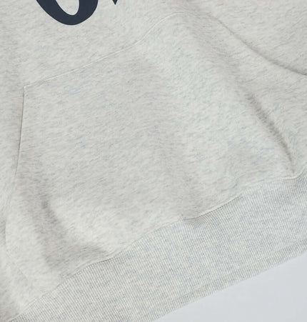 Close-up detail of the Oversized Hooded Sweatshirt – Loose Fit in White Flower Gray fabric with pocket.