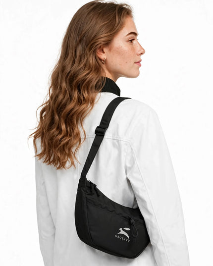 Day bag worn over the shoulder, showing its 12-litre volume